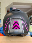 Beautiful example of an application of pink/black chevron reflective sticker on black helmet with pink details, under natural sunlight indoors.