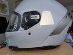 Example of application of a white reflective tetrahedron sticker, comparable to but not certified according to French helmet sticker law.