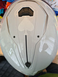 Example of application of a white reflective ace of spades, but without flash, on top of a light grey helmet.